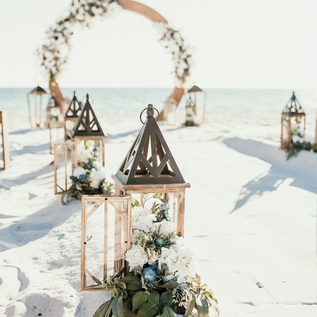 Wedding aisle marker rentals on the beach in Panama City Beach with classic white flowers, eucalyptus, and pops of blue.