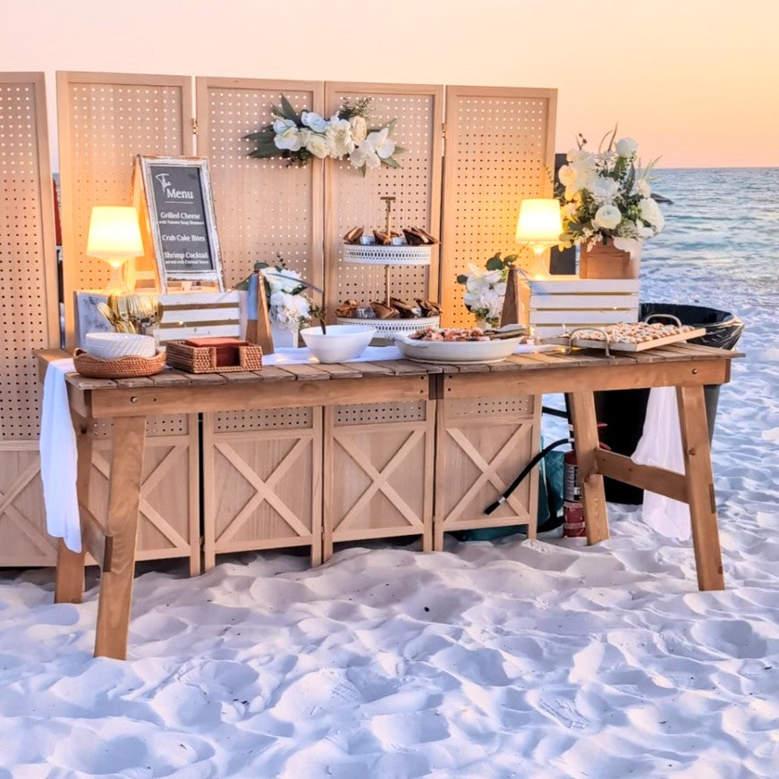 Wooden table setup with decor on a sandy beach in inlet beach 30a