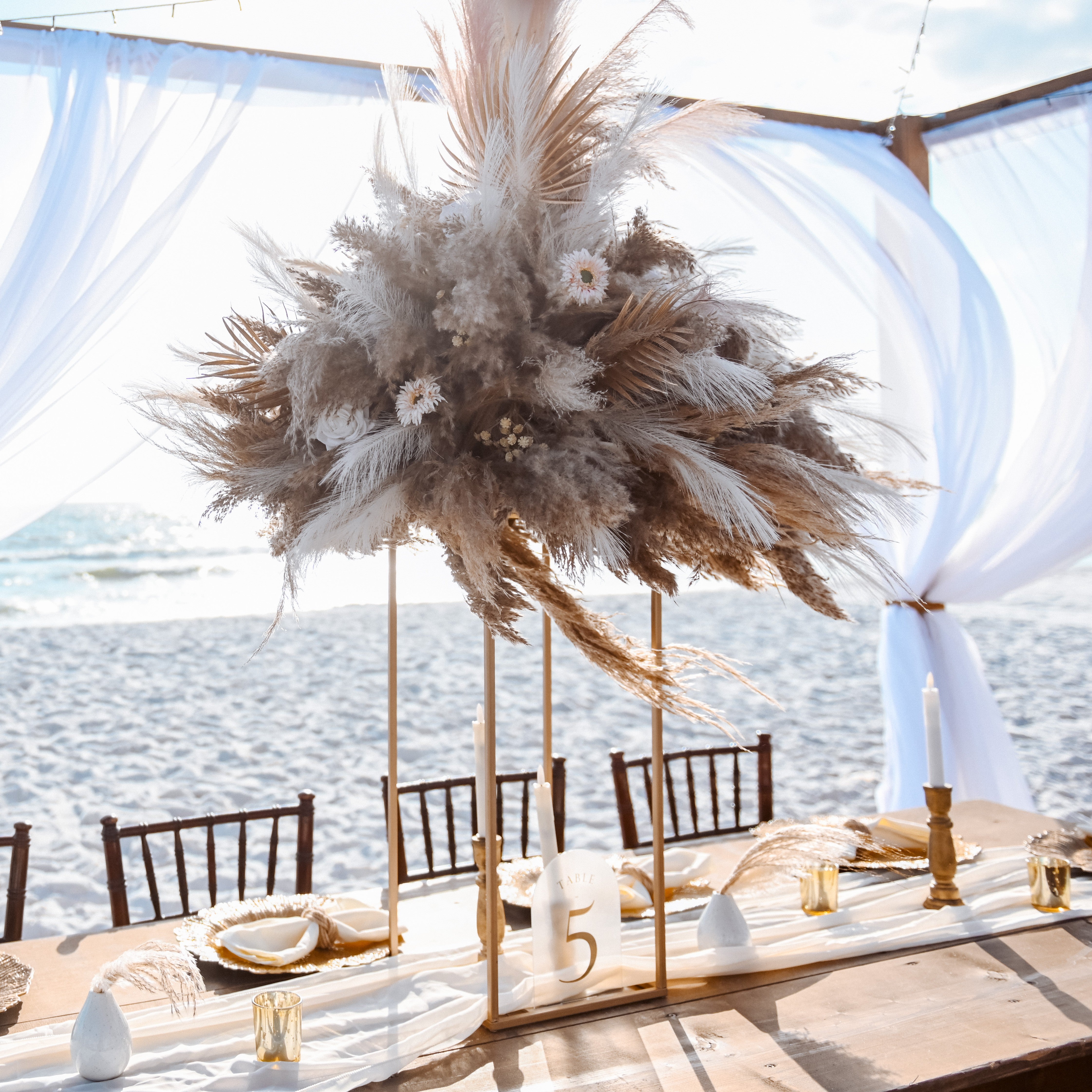 gold open frame flower stand with floral topper centerpiece rental in panama city beach