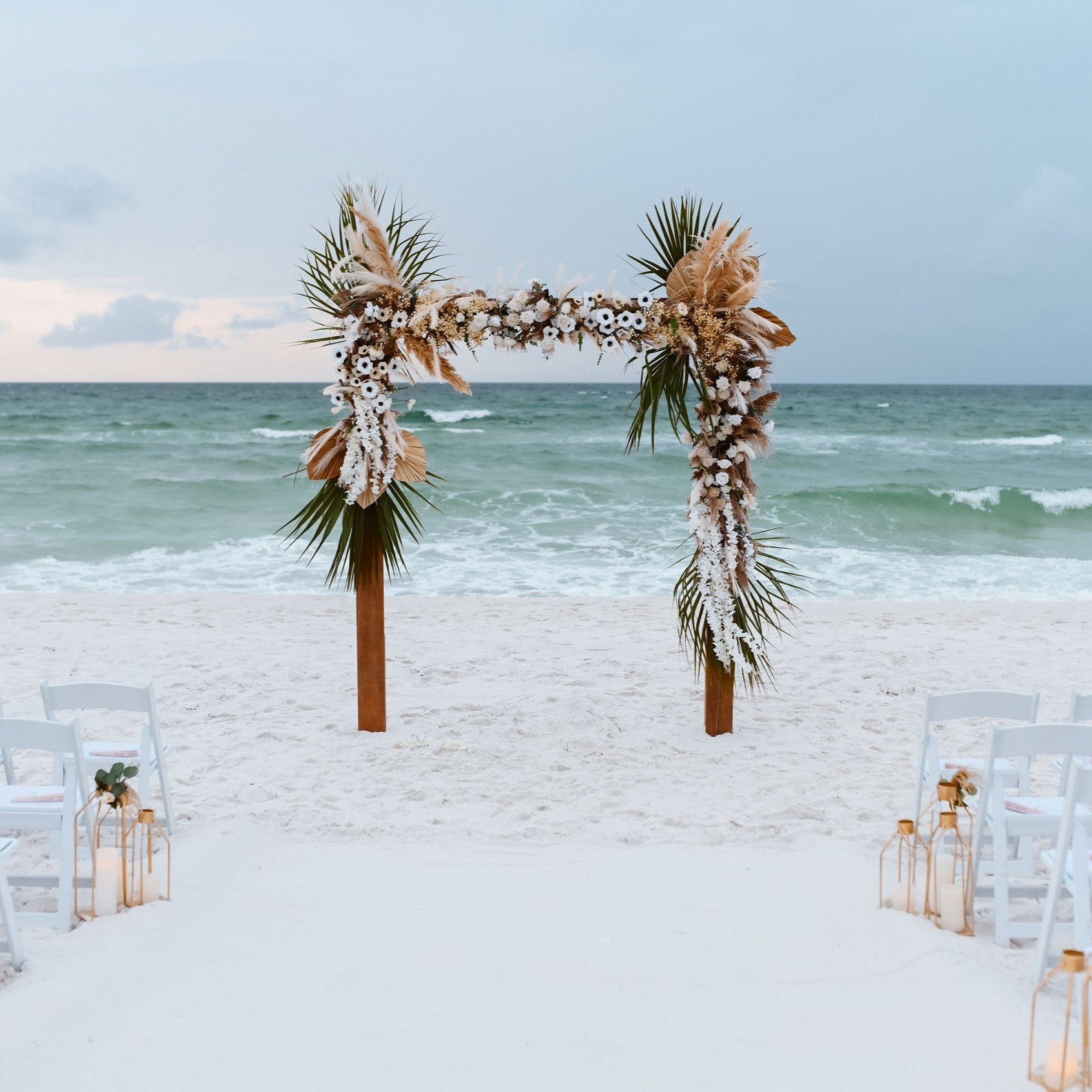 Decorative tropical wedding arch on a beach with ocean view