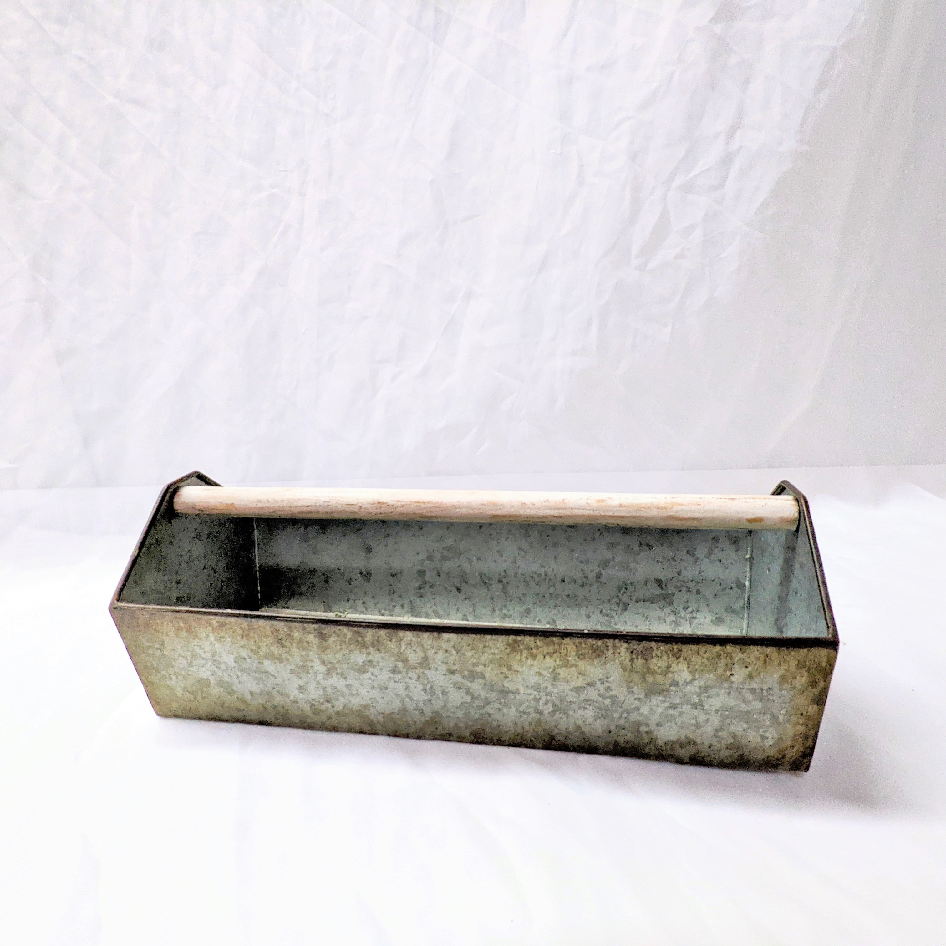 open metal toolbox bin with natural wooden handle for decor or flower vase at wedding or special event