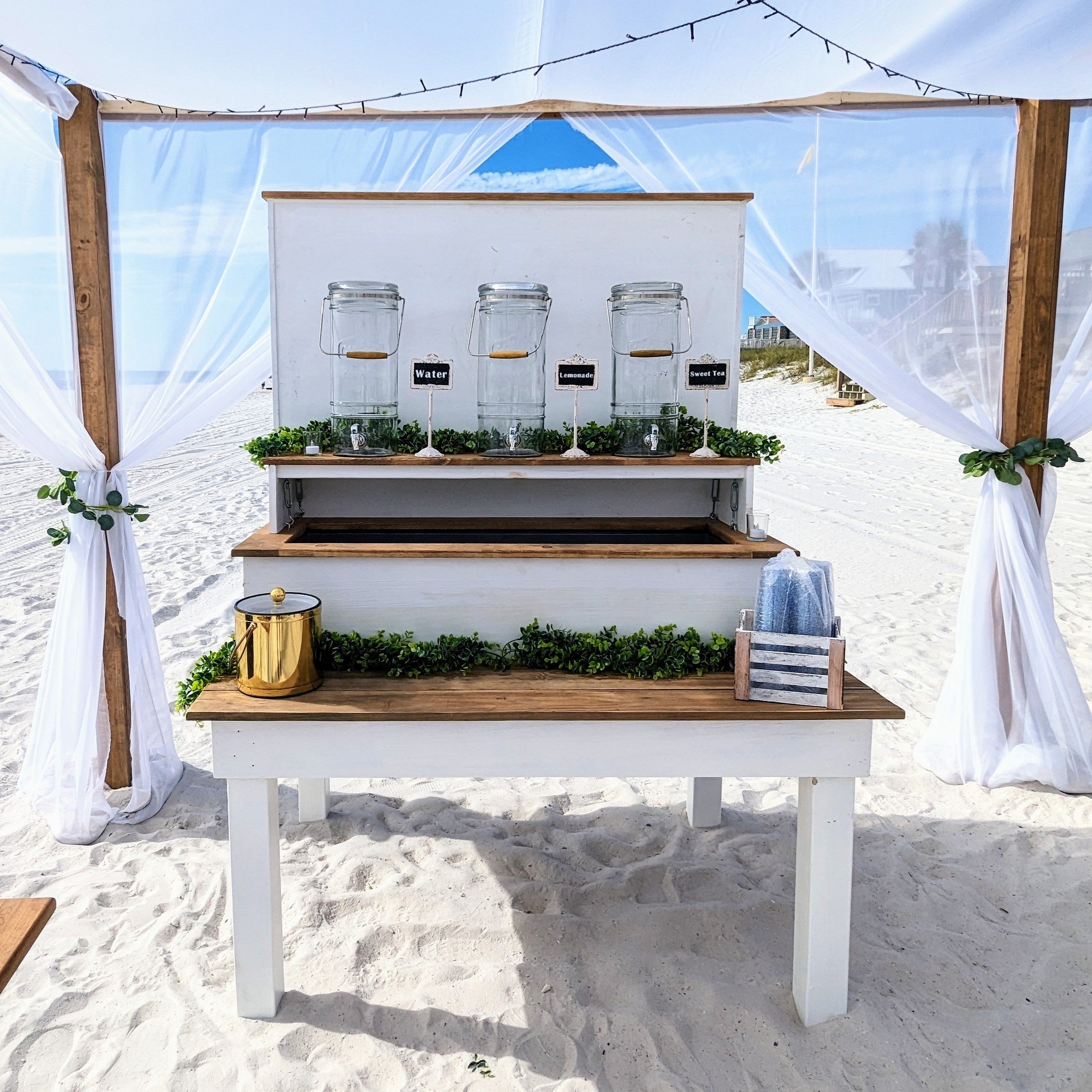 Beach bar rental in panama city beach 30a setup with jars and bottles on a sandy beach
