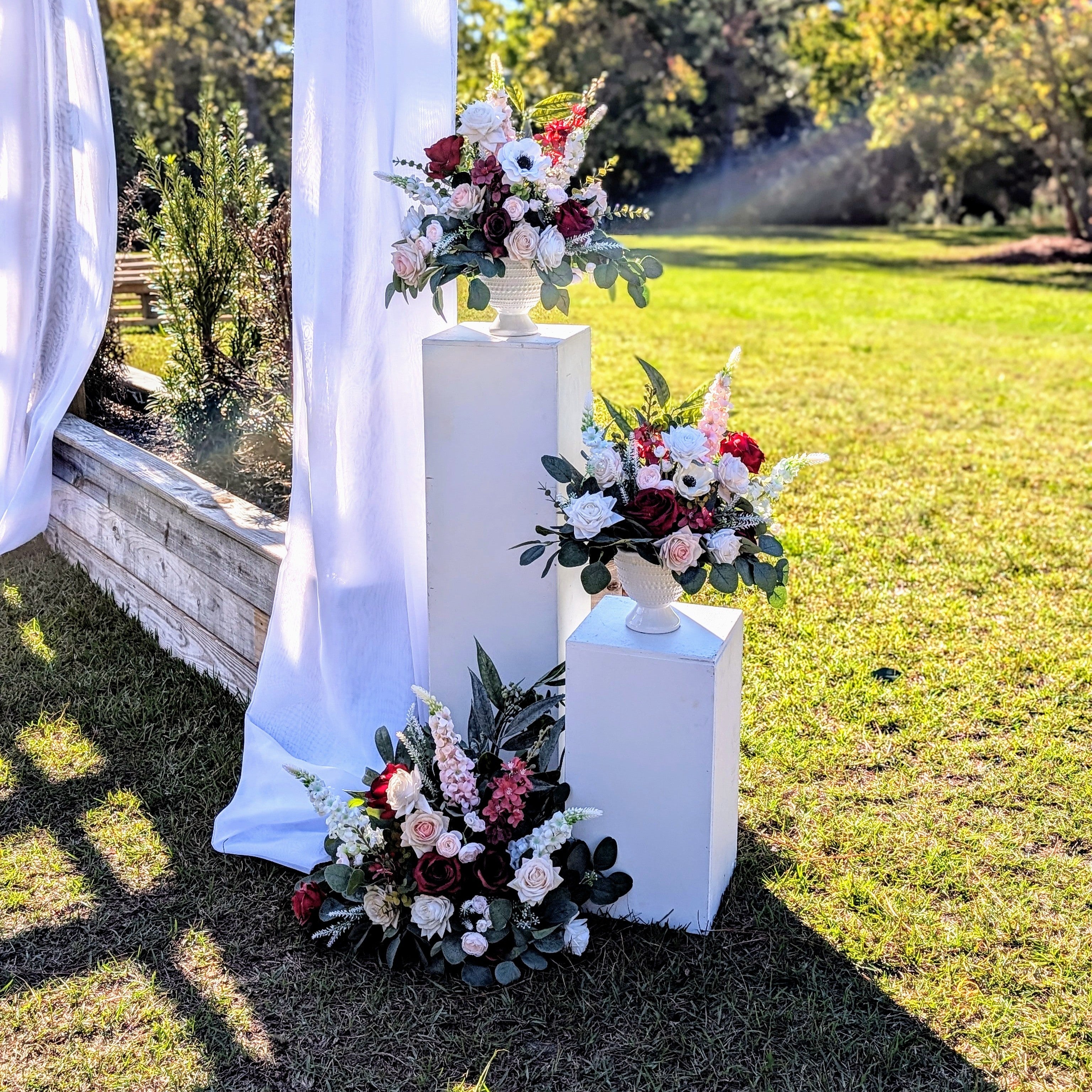 white pillar entry marker with floral topper rental