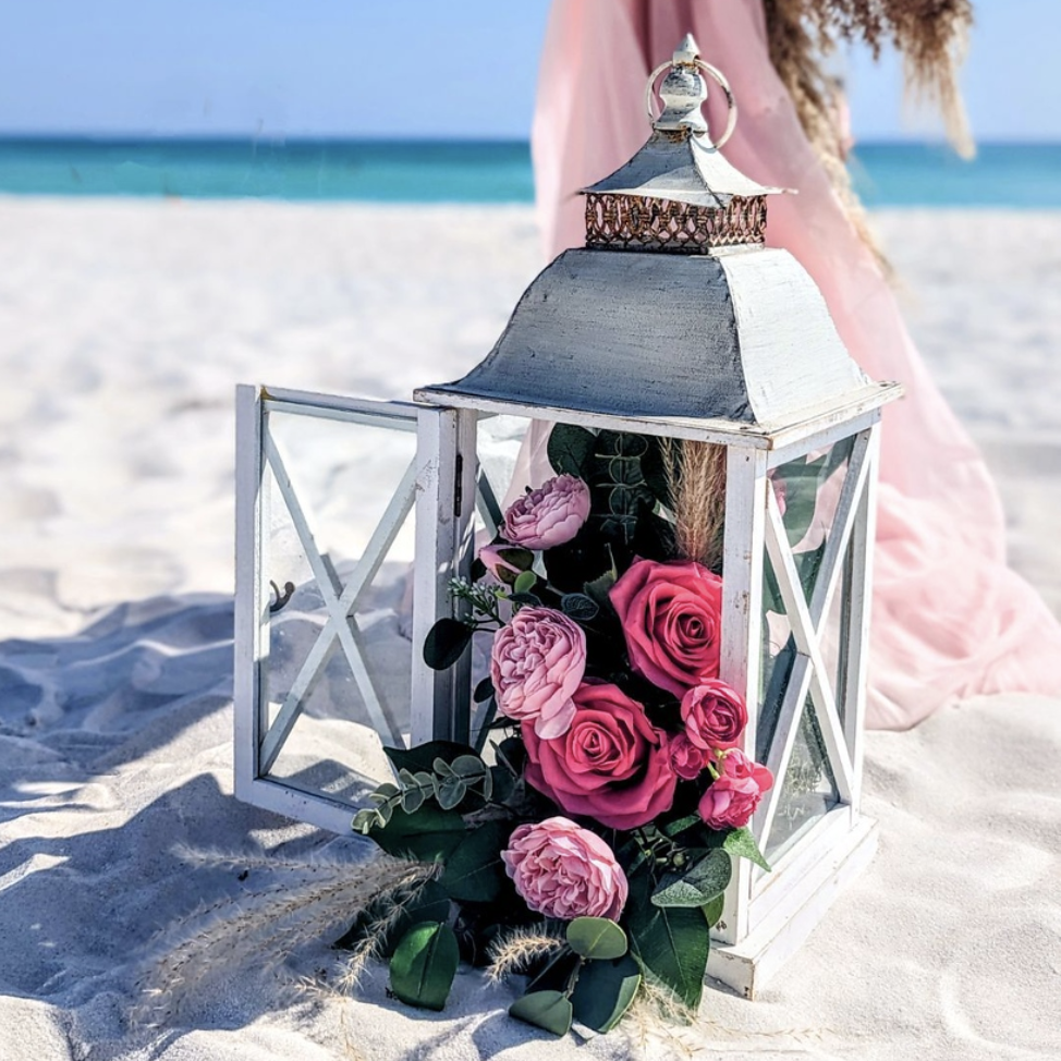 rustic white lantern rental with wedding florist flower spills used as an aisle marker rental for a beach wedding in Panama City Beach PCB Florida