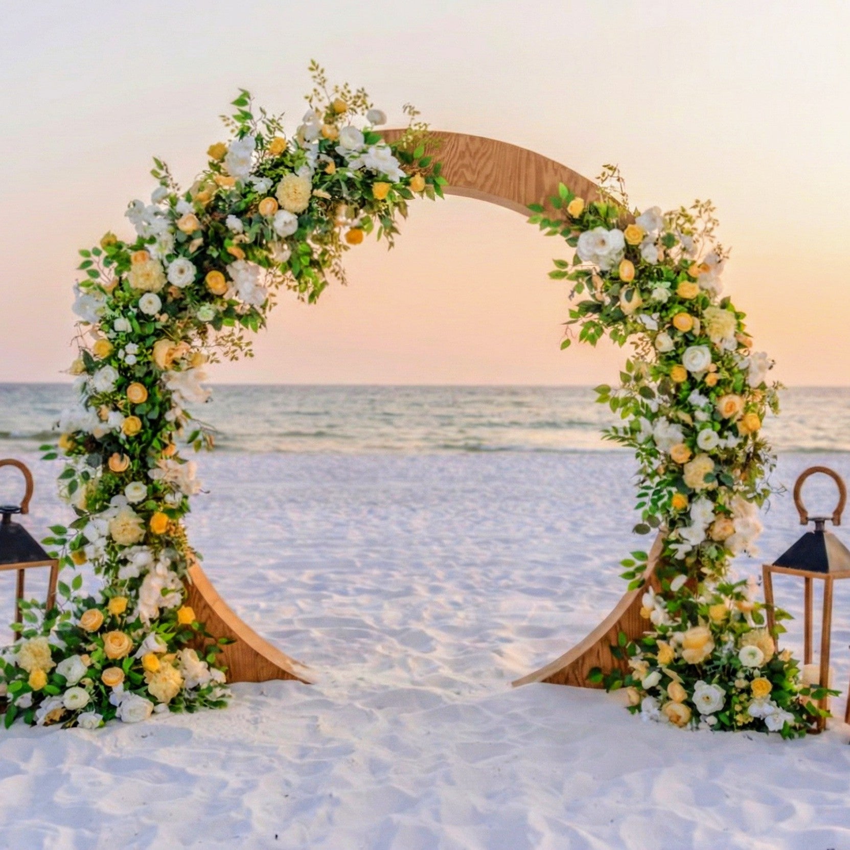 wood circle wedding arbor rental in panama city beach with lush yellow and white flowers