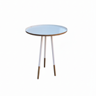 Round side table with a white top and gold legs on a white background
