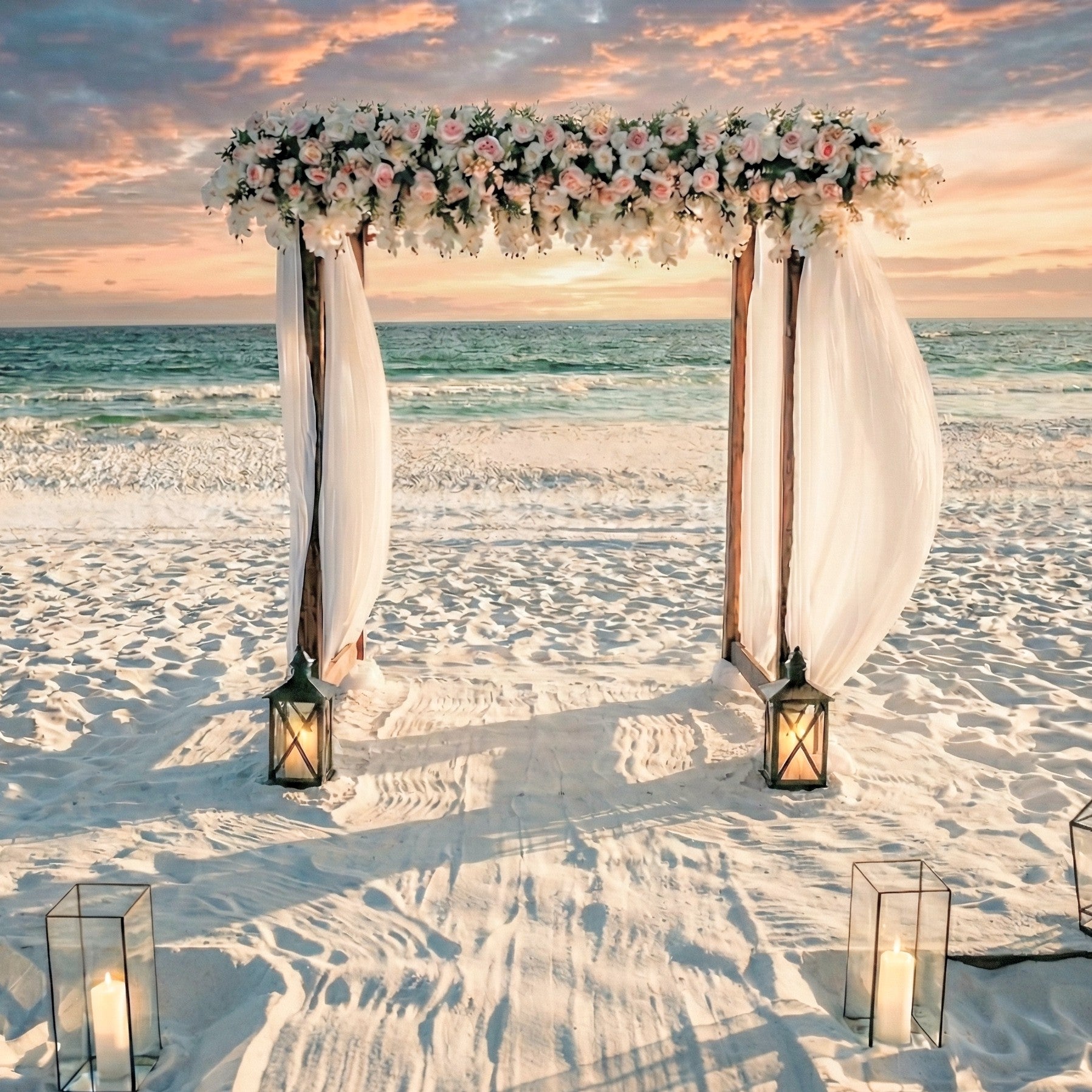 Decorative wedding arch rental with flowers on a sandy beach at sunset
