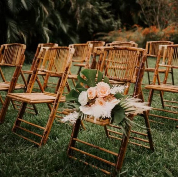Bamboo folding chair rental in Panama City Beach for a wedding, party or event with custom artificial bridal bouquet rental from The Wedding Shop.