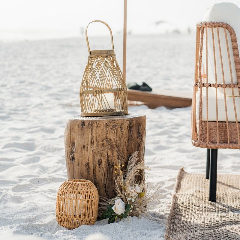 Decorative wicker lanterns and a wooden stool at a luxury beach bonfire in 30a