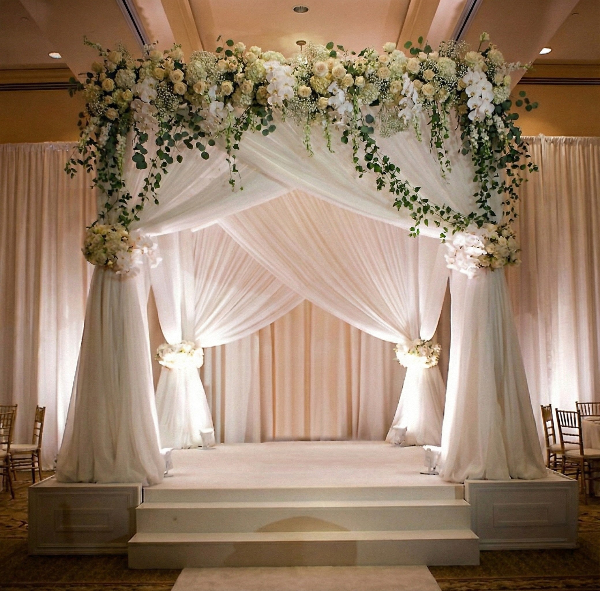 Decorative wedding chuppah rental with flowers and white drapes in panama city beach 30A ballroom wedding