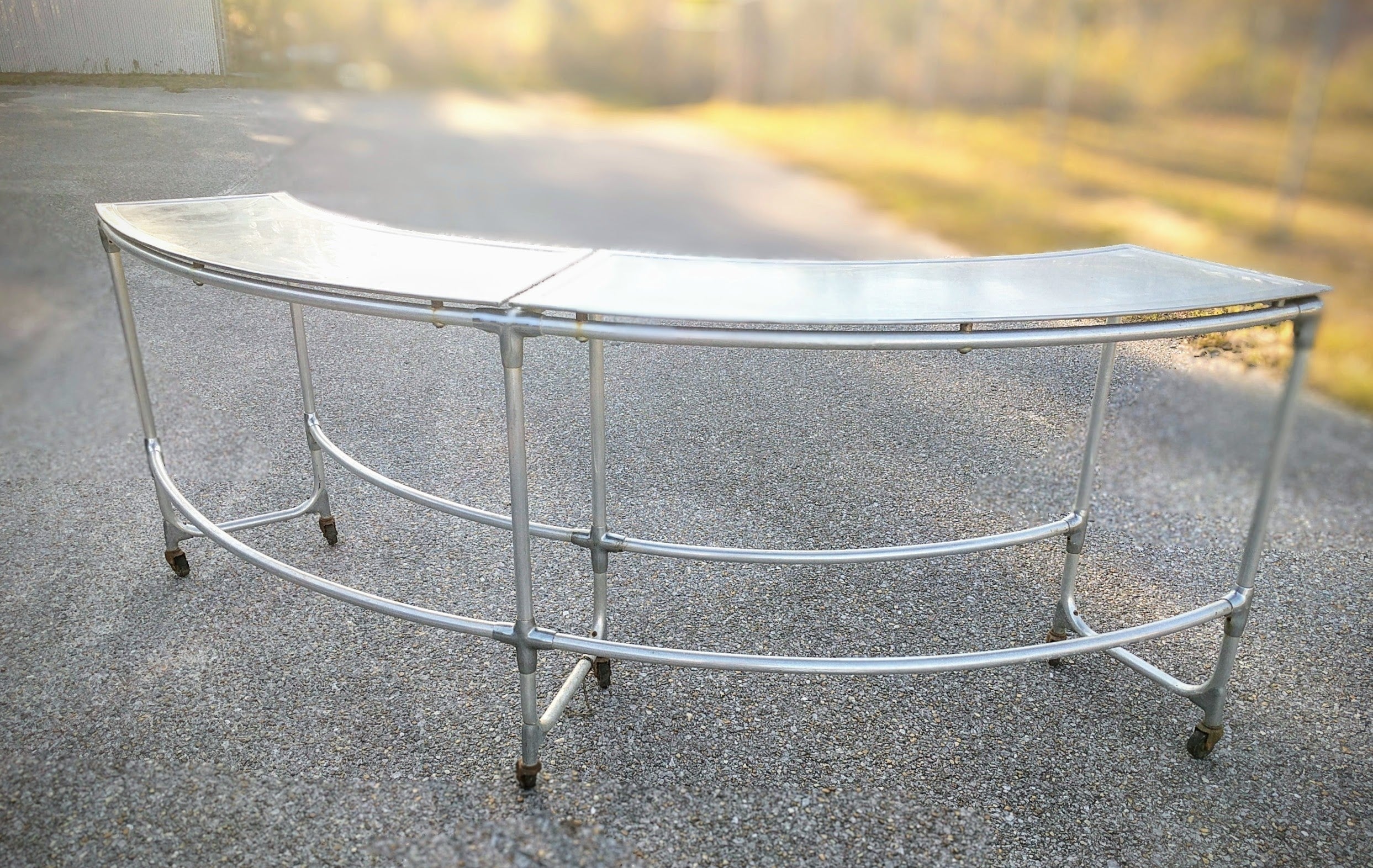 sleek modern curved galvanized metal table for bar or seating 