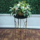 small accent table with round black top and decorative gold metal legs