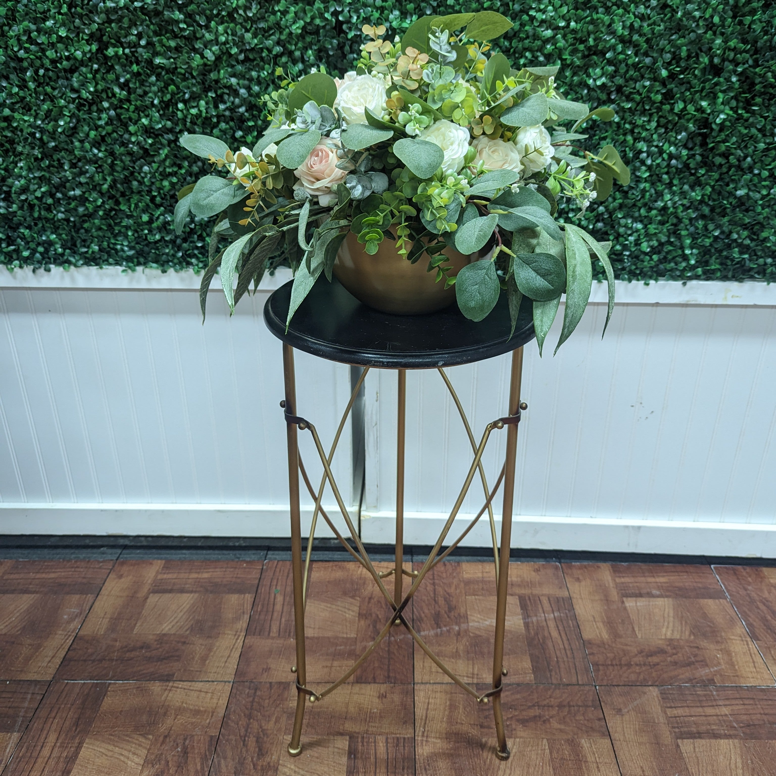 small accent table with round black top and decorative gold metal legs