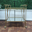 timeless gold metal two tiered bar cart with mirrored shelves 