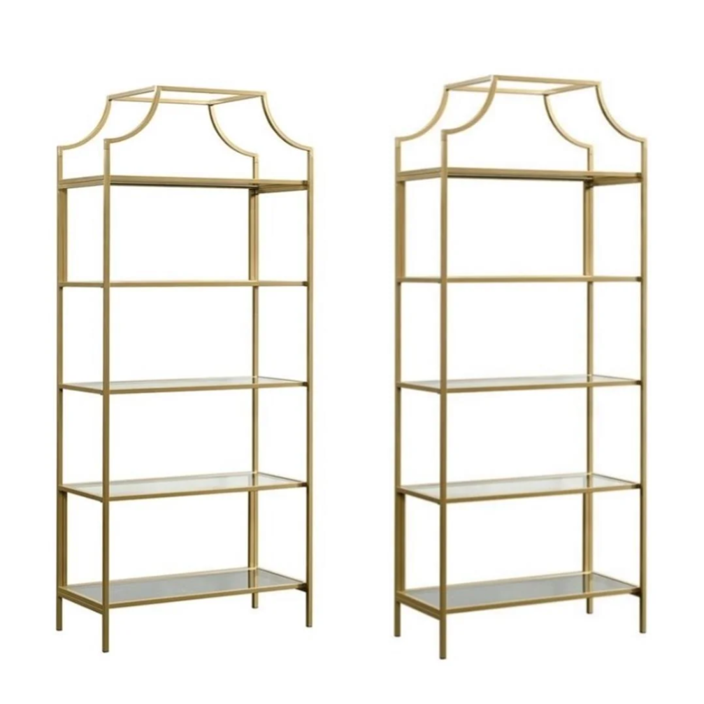 Two gold metal shelves with glass shelves on a white background