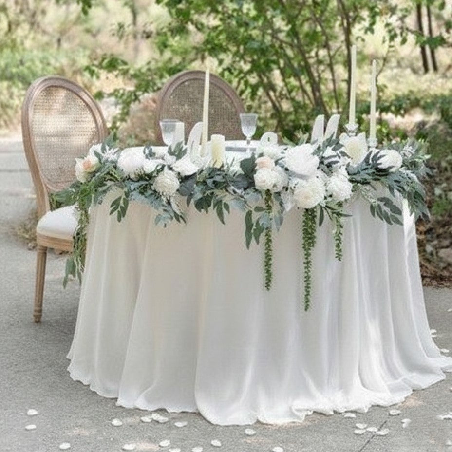 half circle sweetheart table rental with flowers and candles
