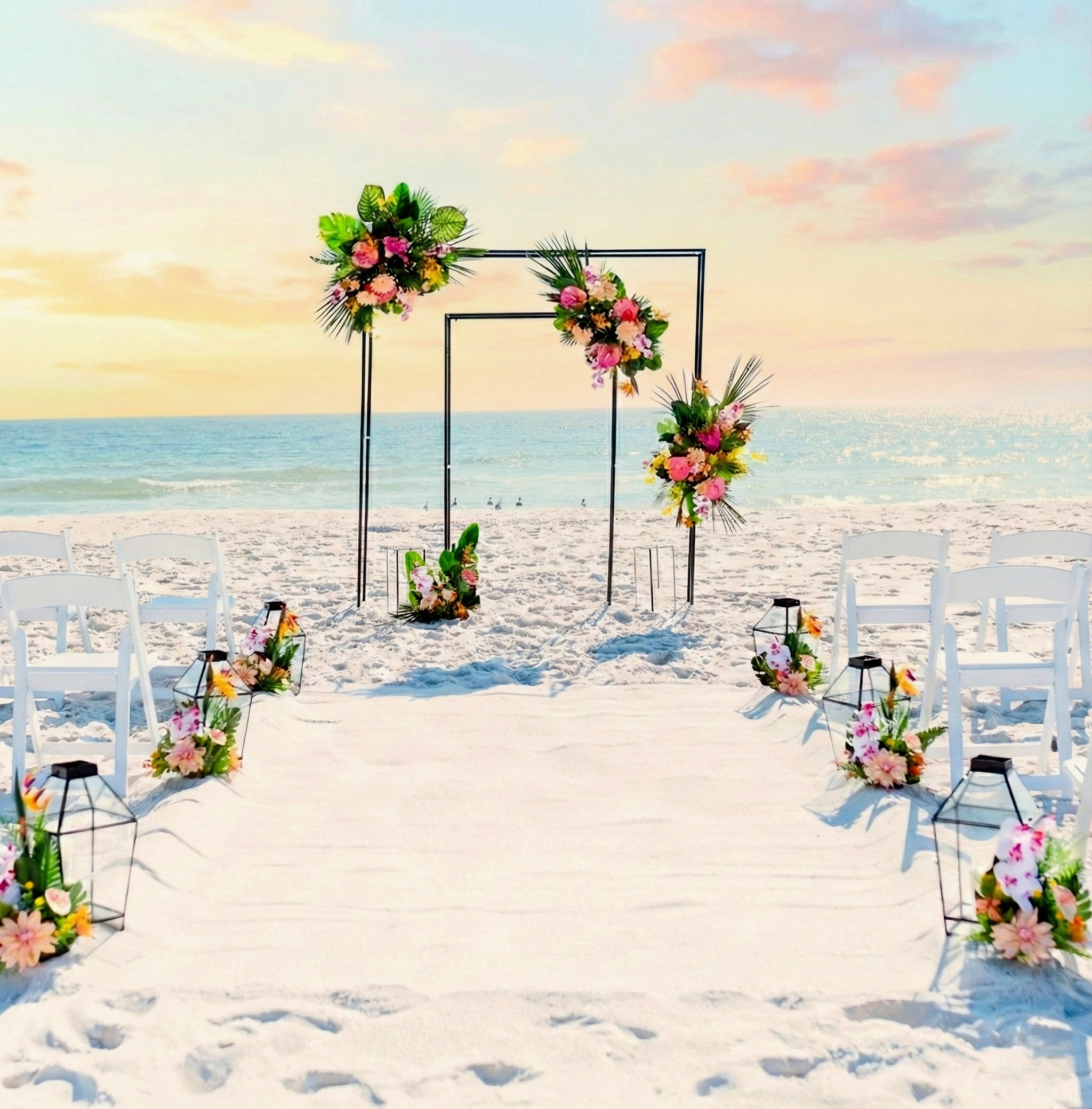 Industrial black wedding arbor rental in panama city beach with tropical flowers at sunset on the beach.
