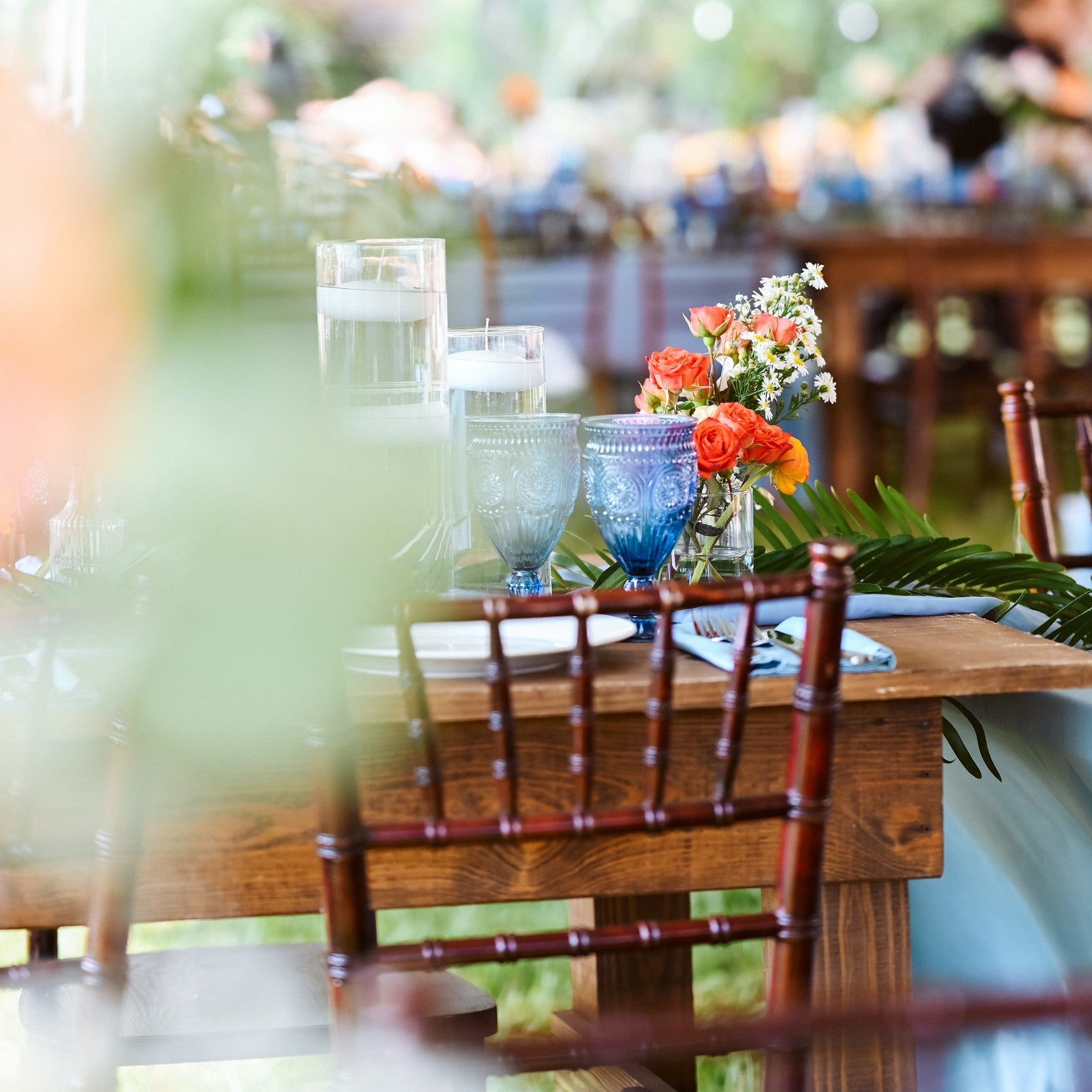 Mahogany chiavari chair rental in the cove near panama city florida for a backyard wedding reception on the bay with our farmhouse table rentals