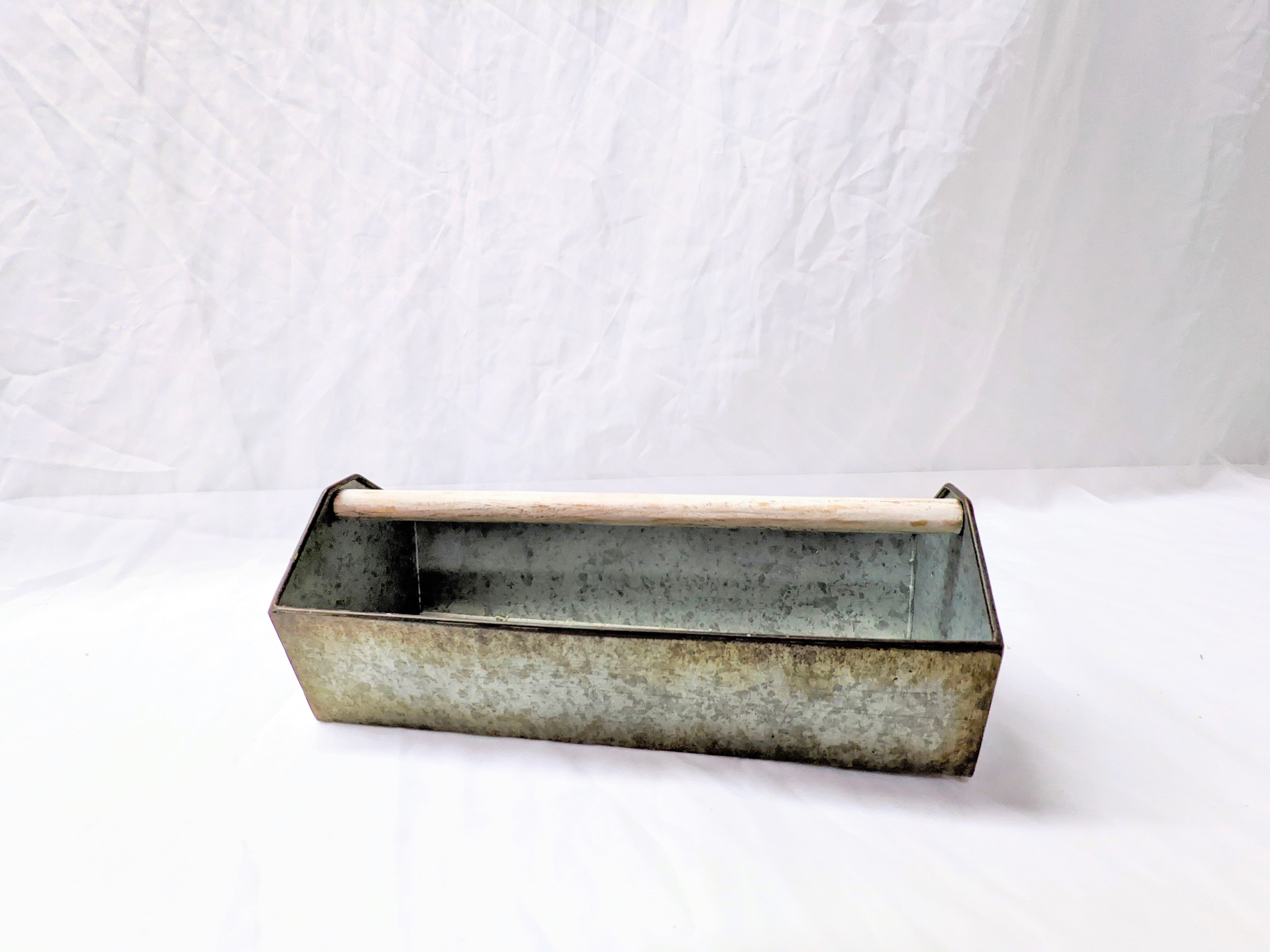 open metal toolbox bin with natural wooden handle for decor or flower vase at wedding or special event 