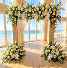 Floral arch rental and decorations in a room with large windows overlooking a beach in panama city beach