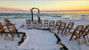 driftwood wedding arbor rental with serpentine aisle design on the beach at sunset