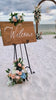 video of beach wedding vow renewal with beautiful wood dome arbor with blue and peach floral accents