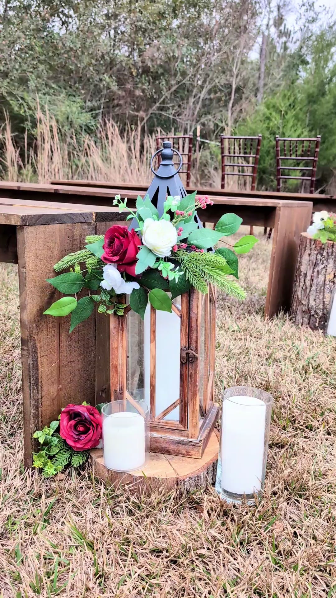 video of rustic wedding ceremony with wood cross in a field.

