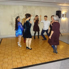 Rustic red oak dance floor setup for outdoor wedding.