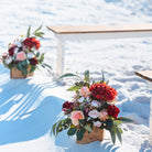 2-toned spindle leg bench seating rental for a beach wedding ceremony with red, pink, and white flower aisle markers by the wedding shop for a beach wedding in panama city beach on the emerald coast