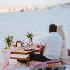 luxe sunset picnic date night on the beach in panama city florida at sunset