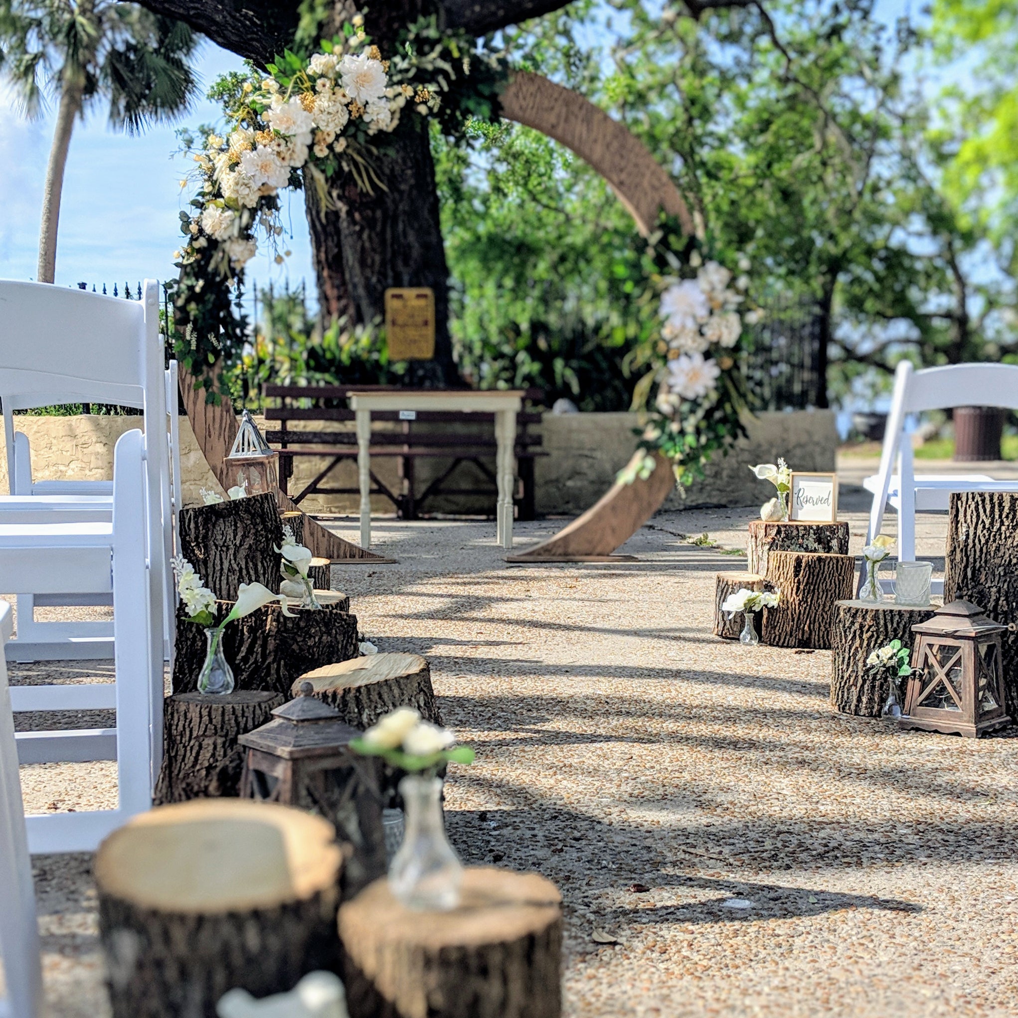 wood circle moon gate wedding arch arbor beach wedding rental in panama city beach with log stump aisle markers