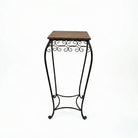 Small side table with wooden top and black metal stand on a white background