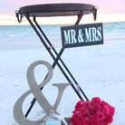 Decorative sign with 'Mr & Mrs' and pink roses on a light blue background