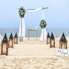 destination-beach-wedding-elopement-arbor-arch-rental-decorations-lantern-aisle-markers-panama-city-beach-wedding-planner-officiant-photographer-rentals-unity-ceremony-table-rental